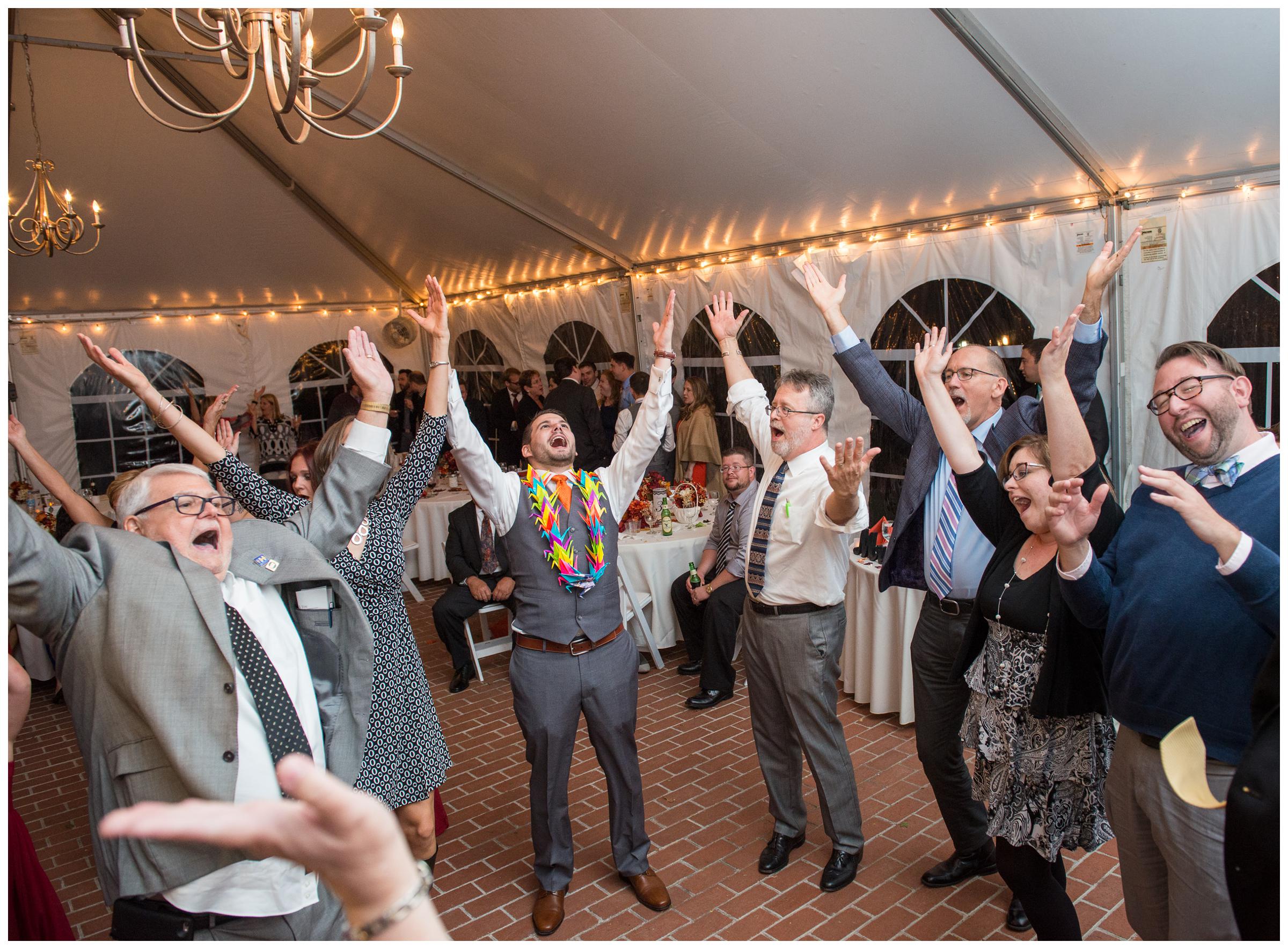 guests dance to the YMCA at tented wedding reception