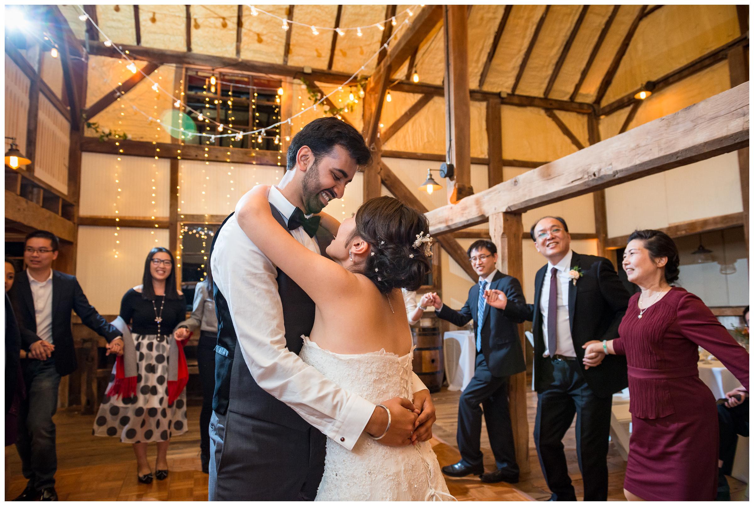 bride and groom dancing at rustic barn wedding reception