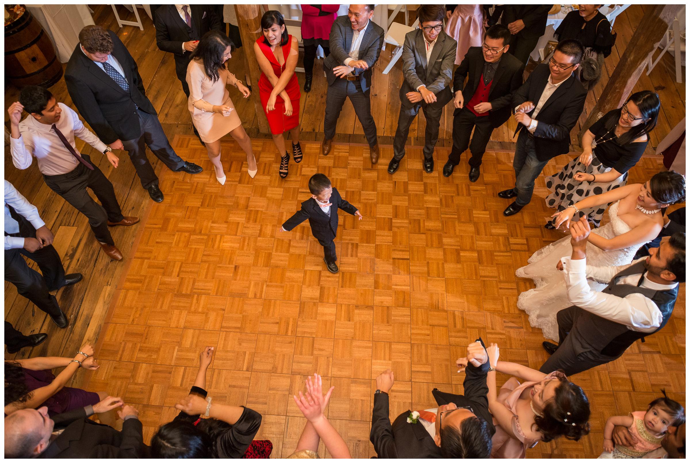 child dancing in circle during wedding reception at Stoneleigh Golf and Country Club in Virginia