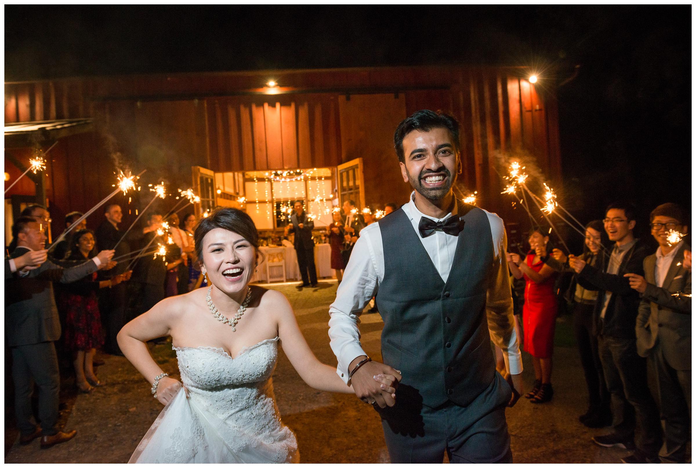 bride and groom sparkler exit from barn