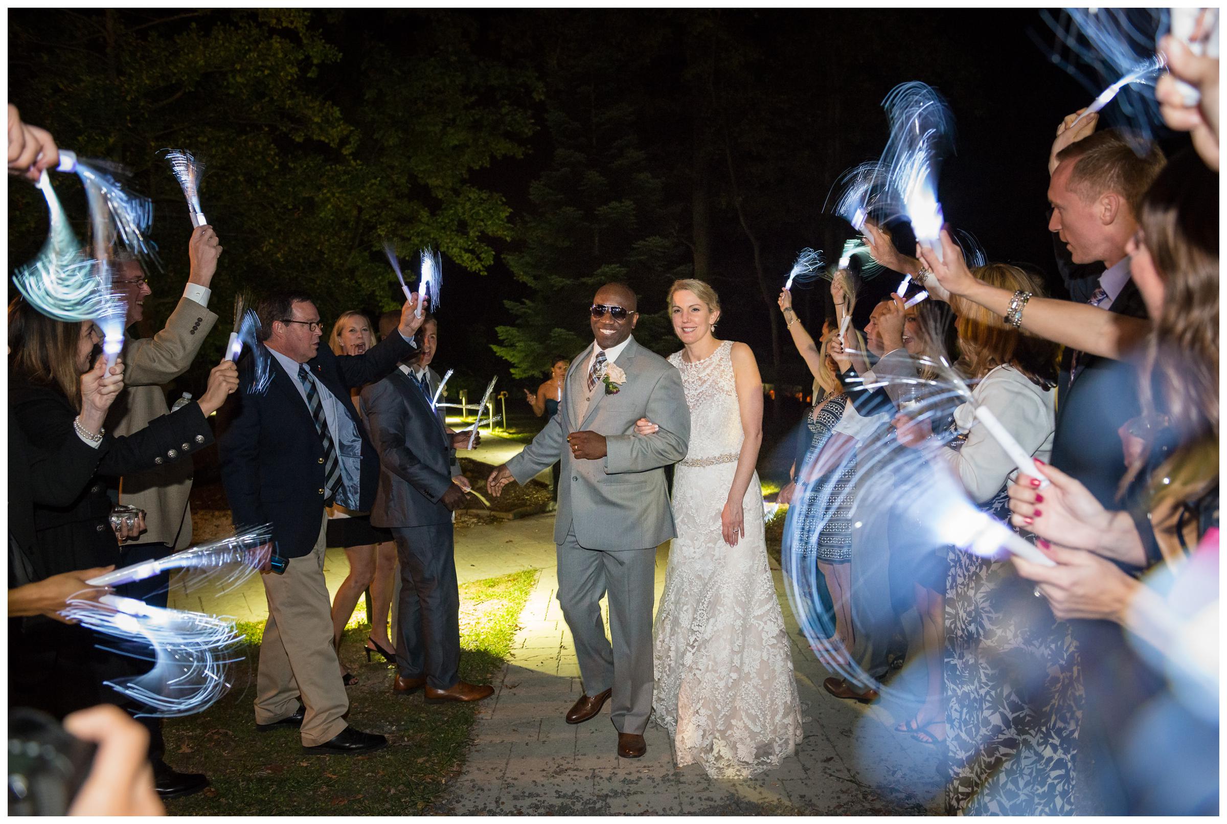 bride and groom during glow stick reception exit