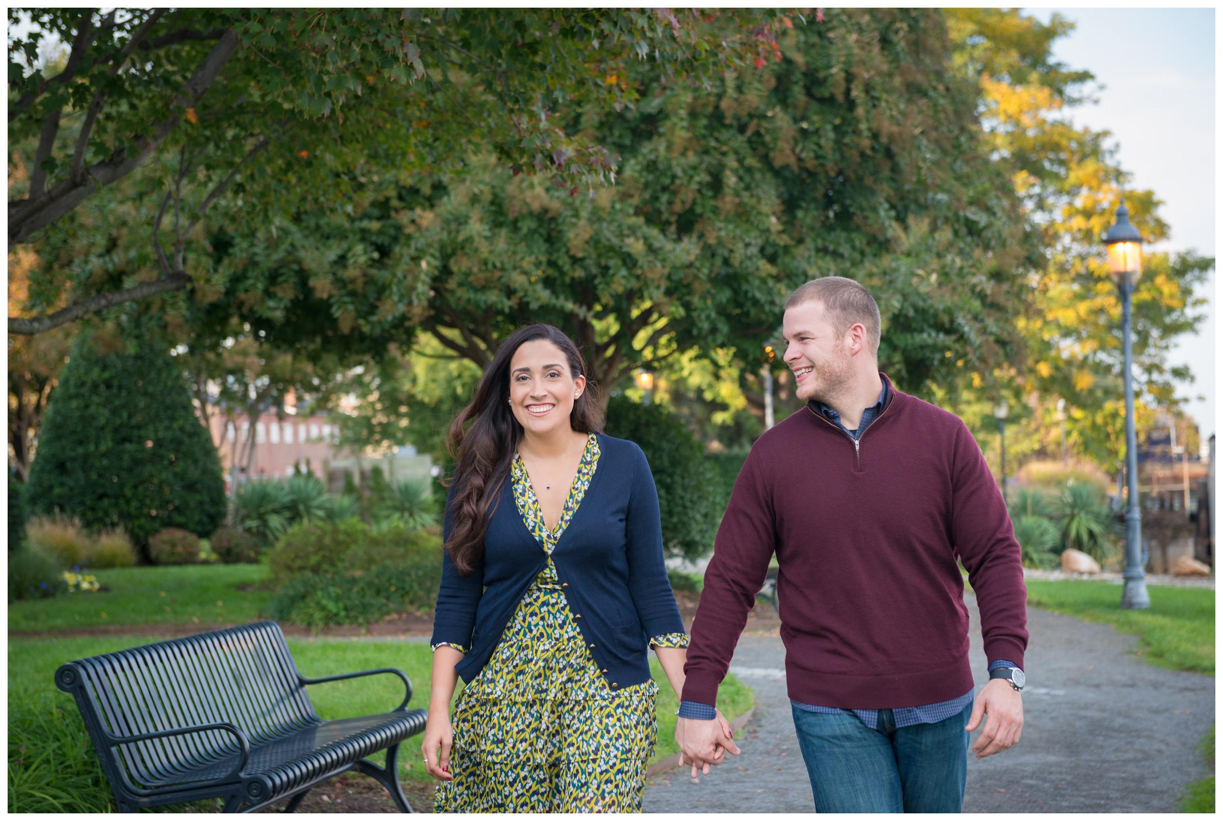 engaged couple walking and holding hands