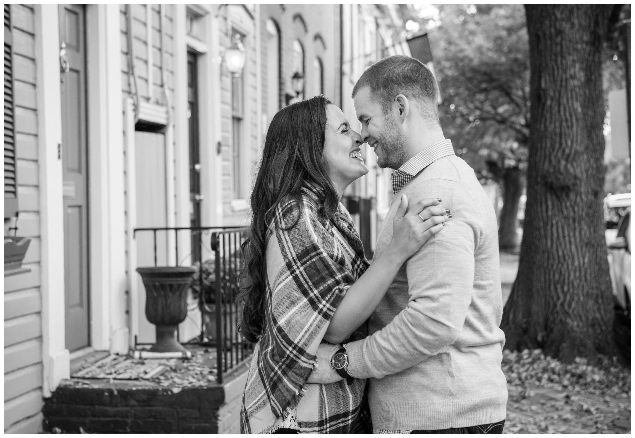 engaged couple hugging on historic street in Old Town Alexandria