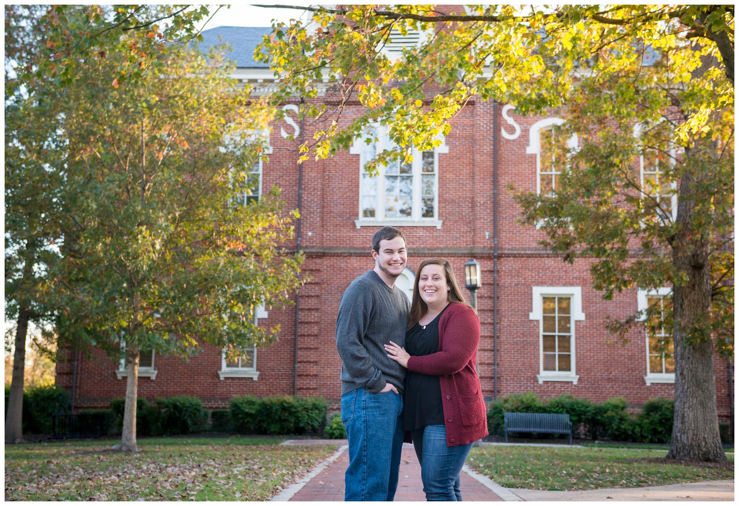 Engaged couple near fountain on Randolph-Macon campus in Ashland, Virginia.