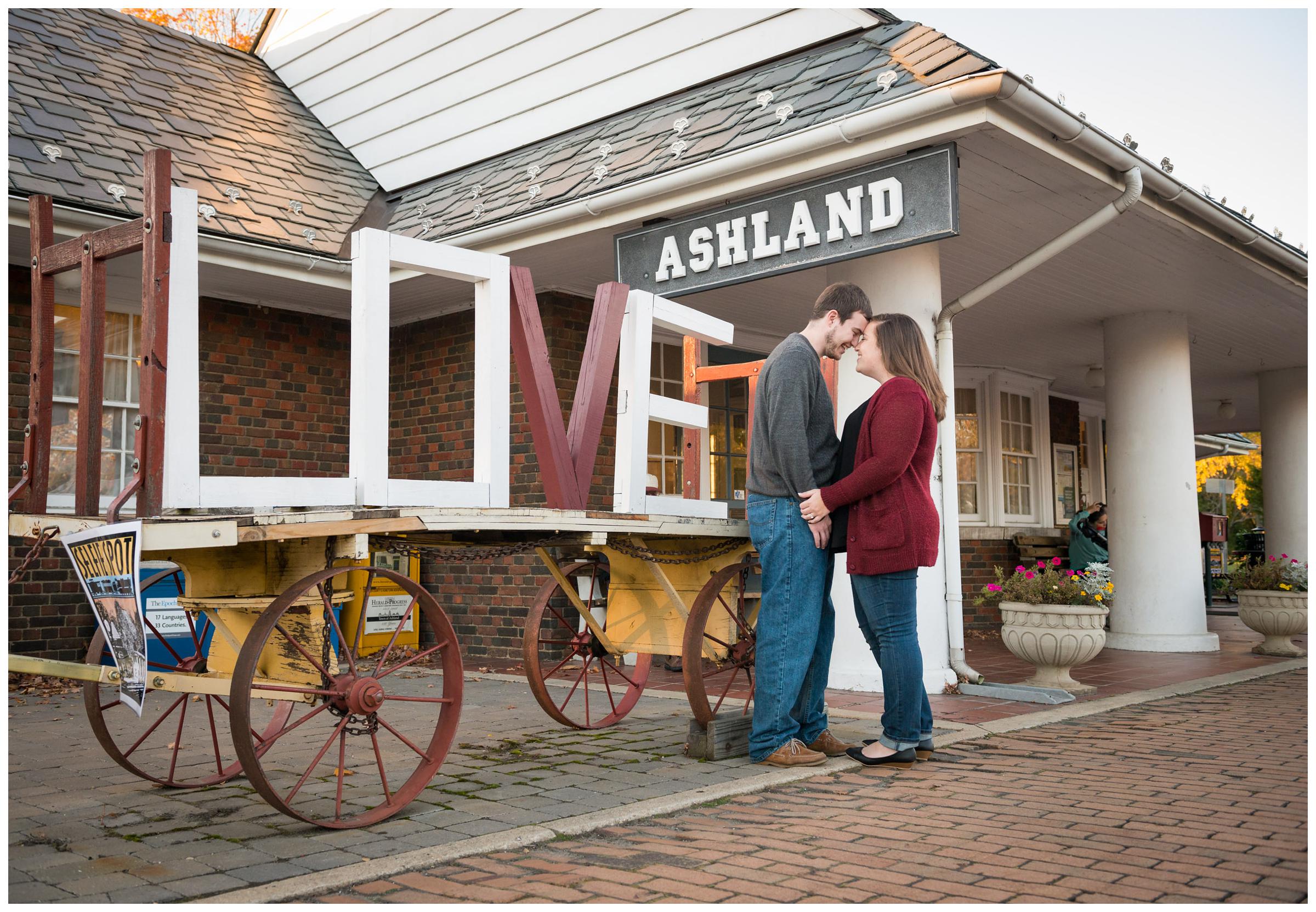 Engagement photos with LOVE sign near train station in Ashland, Virginia.