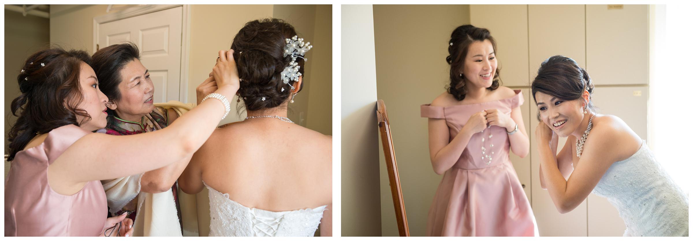 Bride getting dressed with bridesmaid and mom before wedding ceremony.