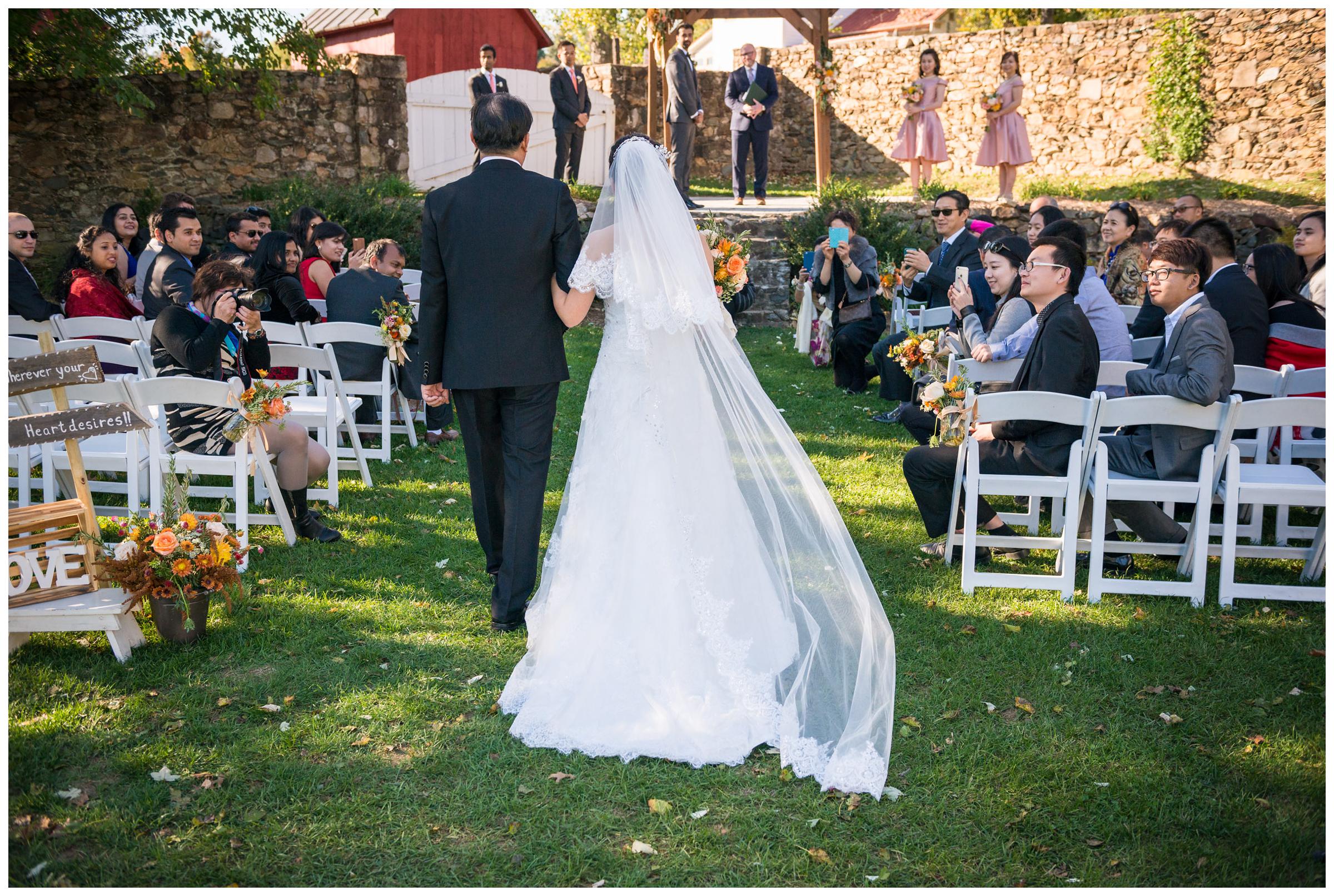 Bride escorted down the aisle by her father.