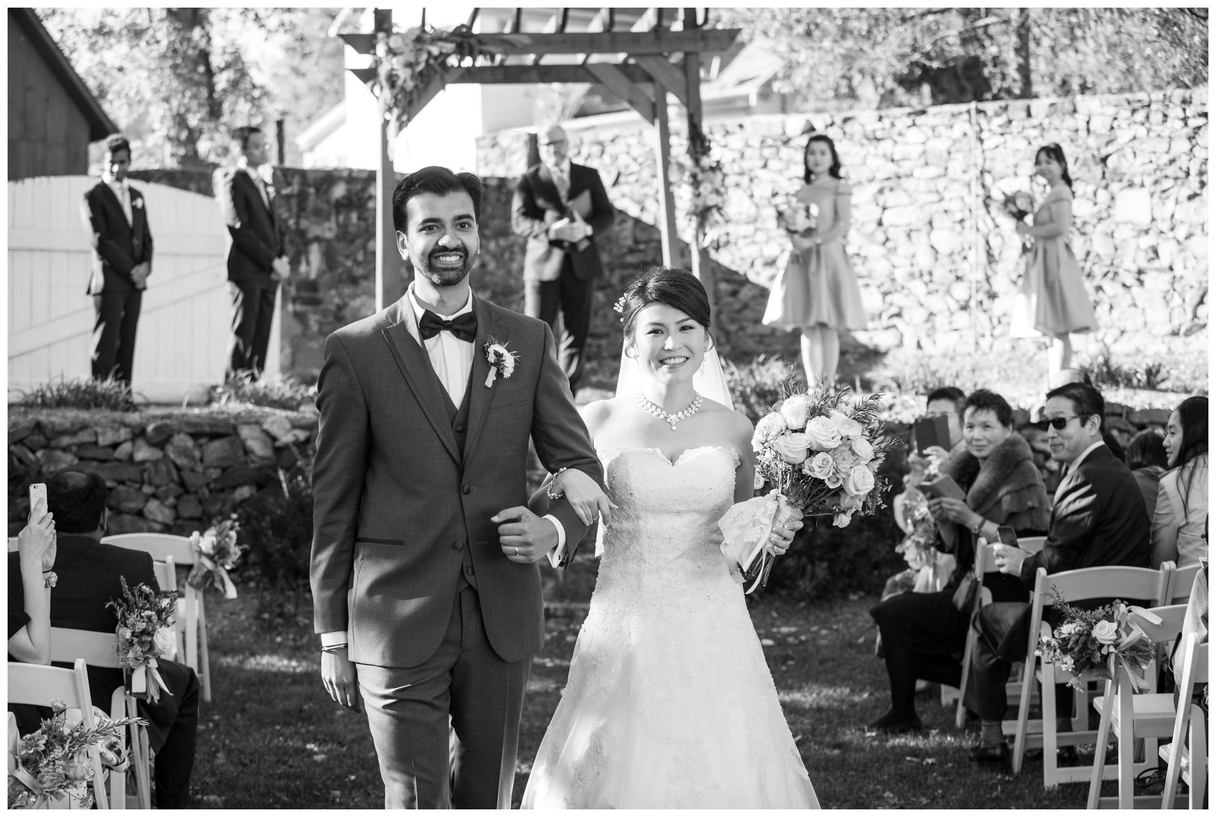 Recessional during rustic outdoor wedding ceremony.