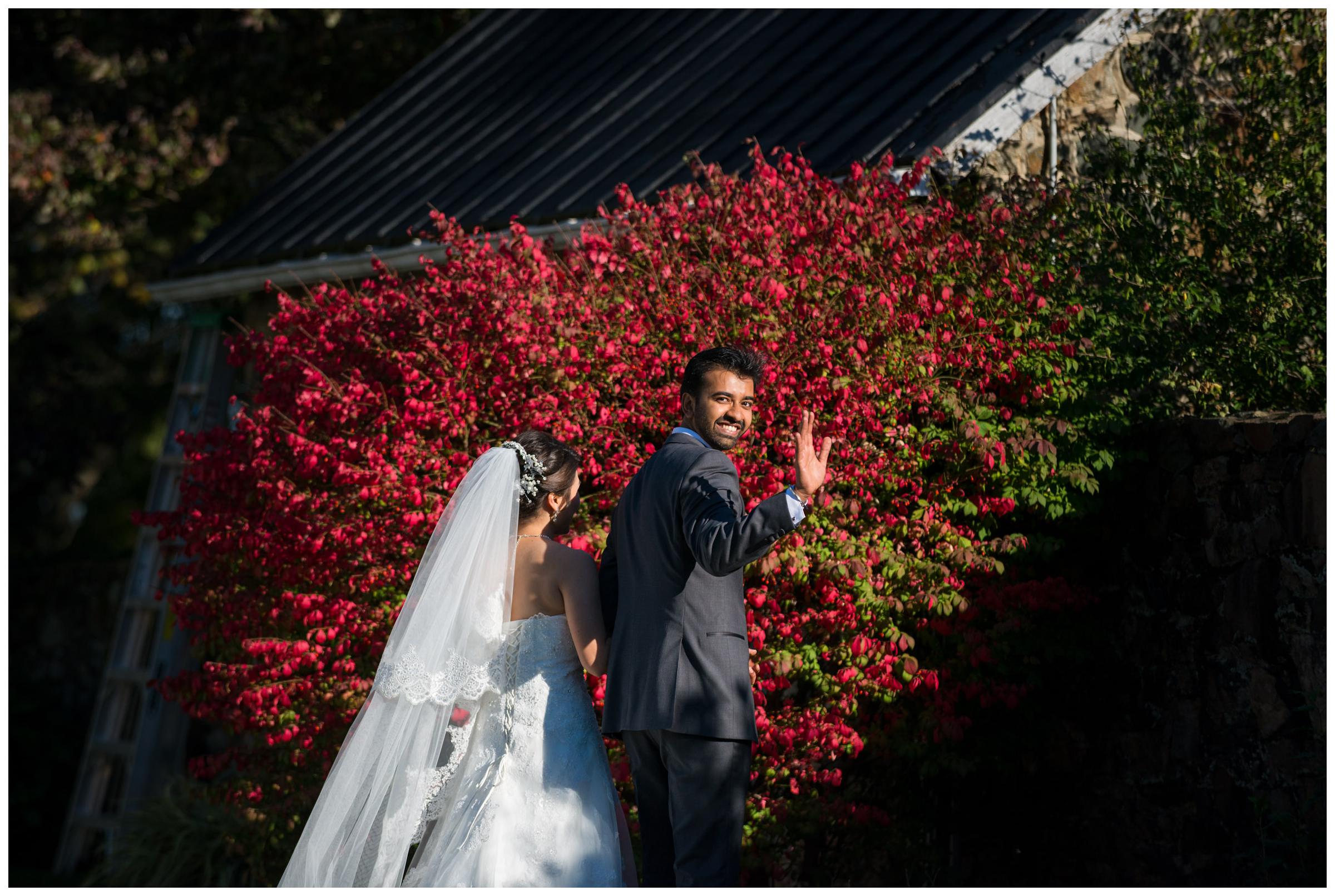 Groom waving as he exits wedding ceremony.