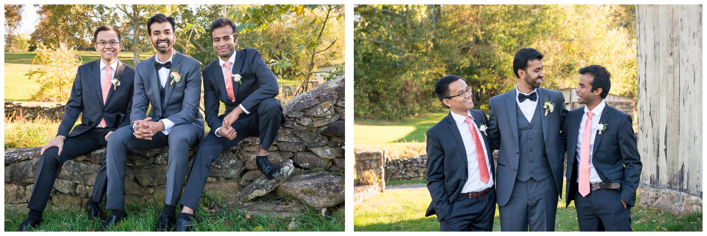 Portrait of groomsmen near stone ruins at rustic wedding.