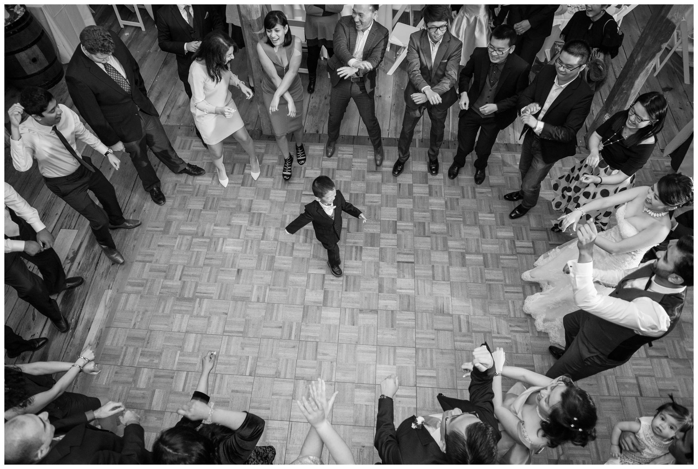 The ring bearer danced in the center of the floor during a rustic wedding reception.