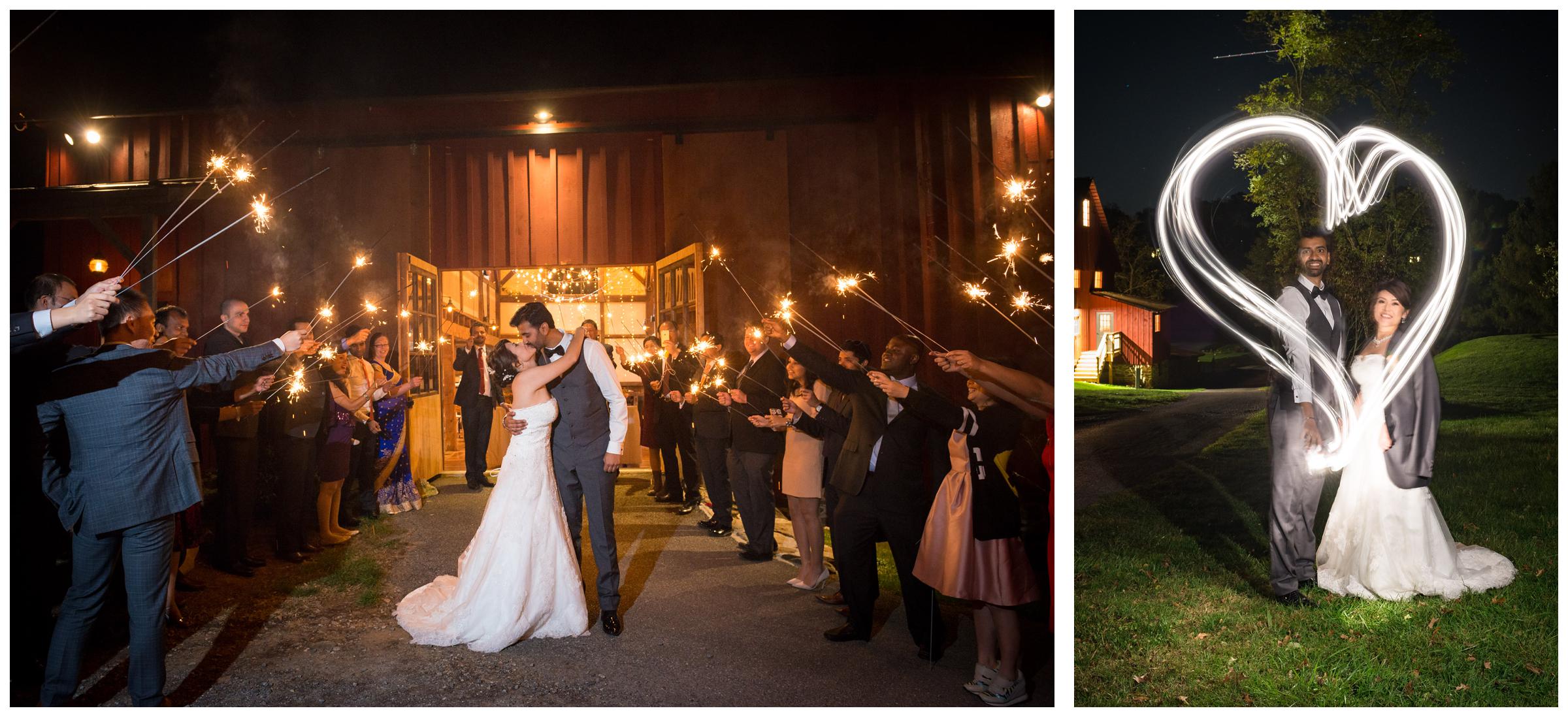 Sparkler exit from rustic wedding reception in barn and light painted heart around newlyweds. 