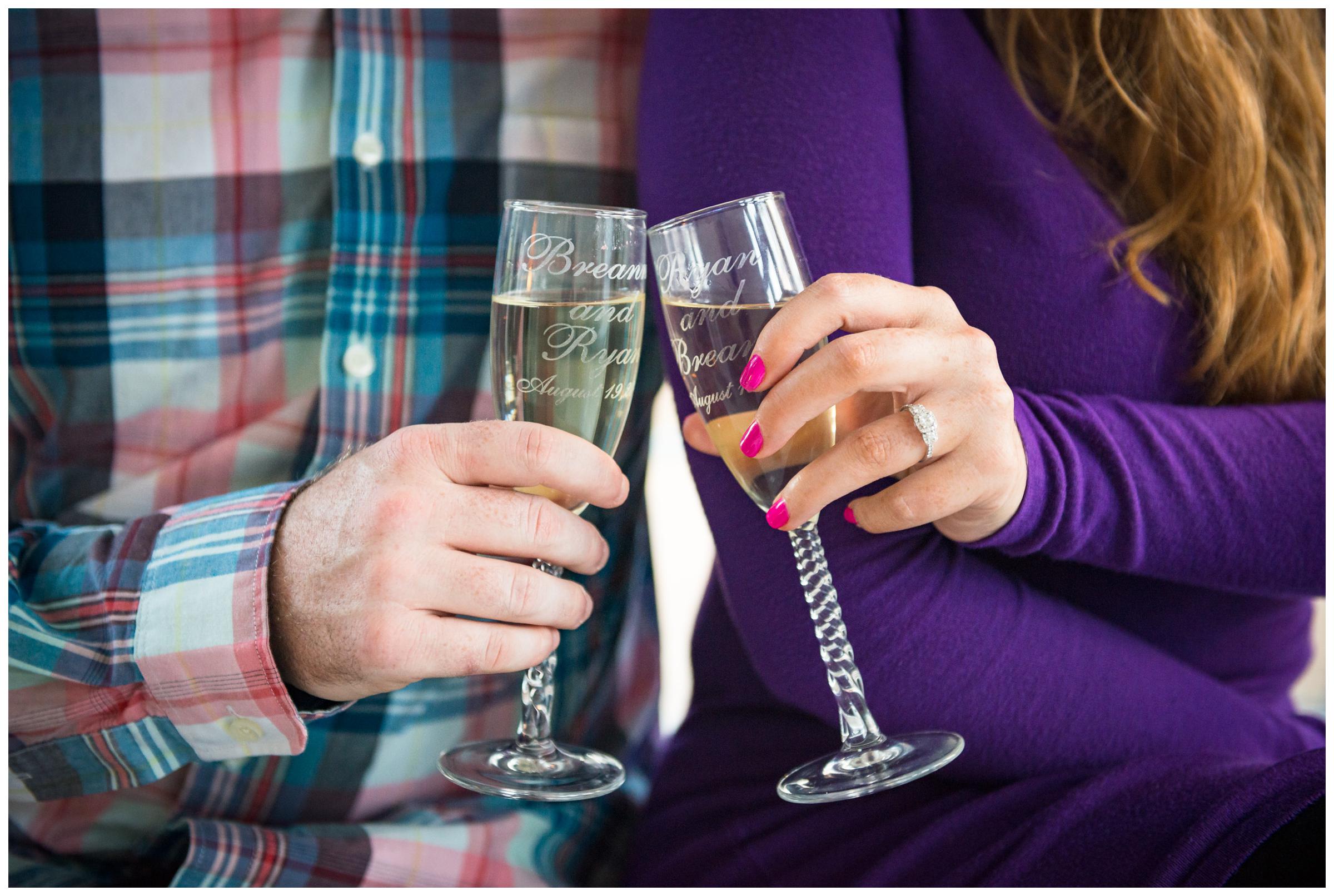 Engaged couple cheers with personalized champagne flutes