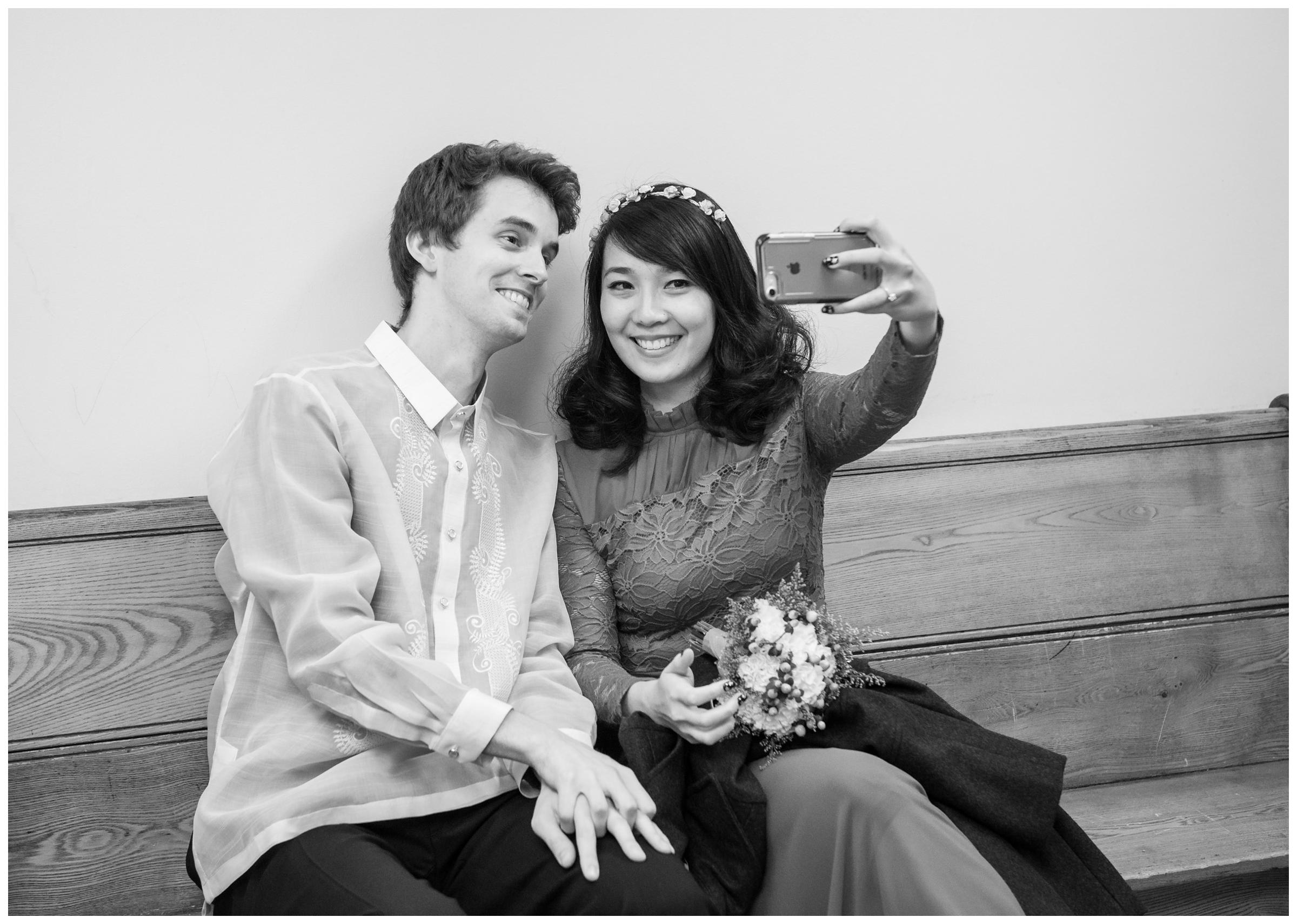 bride and groom taking selfie before elopement wedding at Montgomery County Courthouse in Rockville, Maryland