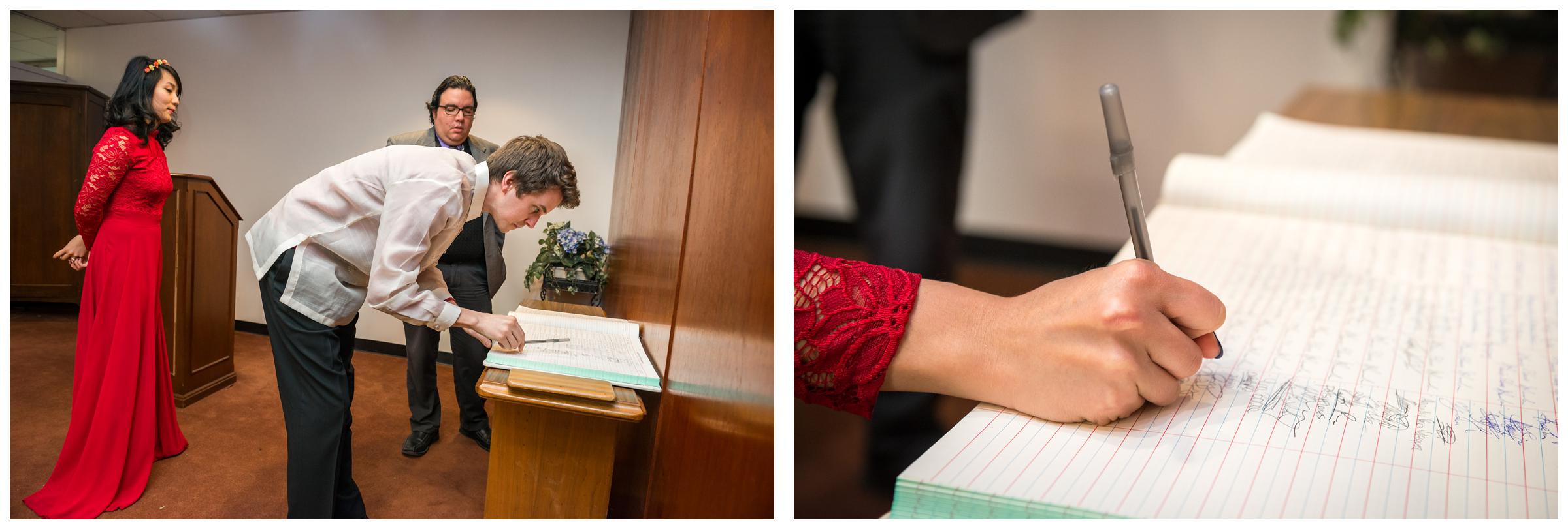 bride and groom signing marriage registry during elopement wedding at Montgomery County Courthouse in Rockville, Maryland