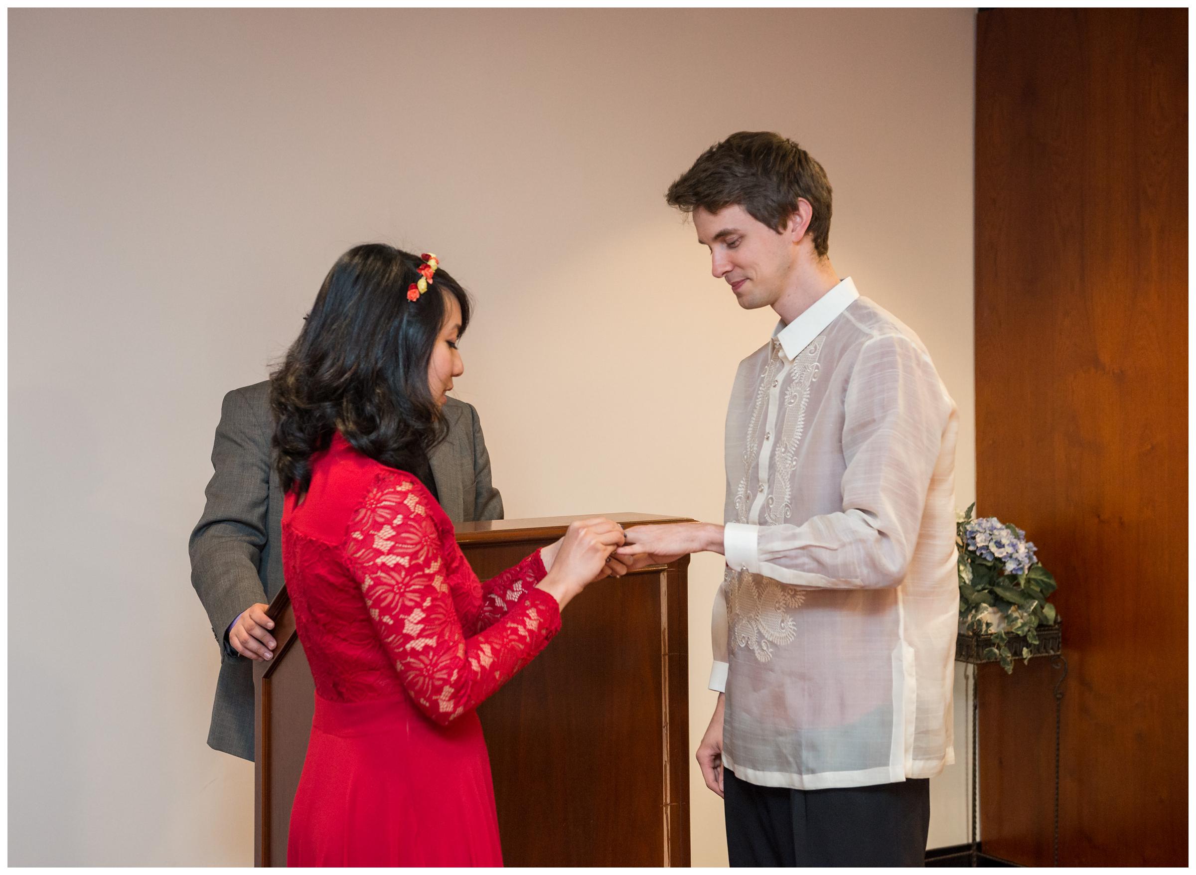 bride and groom exchanging rings during elopement wedding at Montgomery County Courthouse in Rockville, Maryland