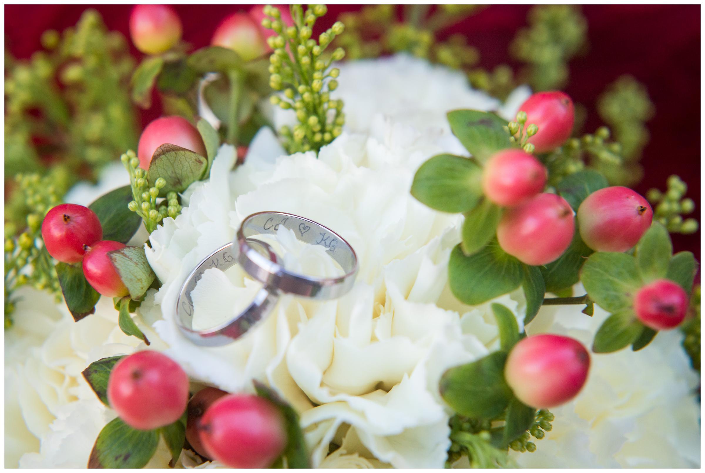 engraved wedding rings on bouquet