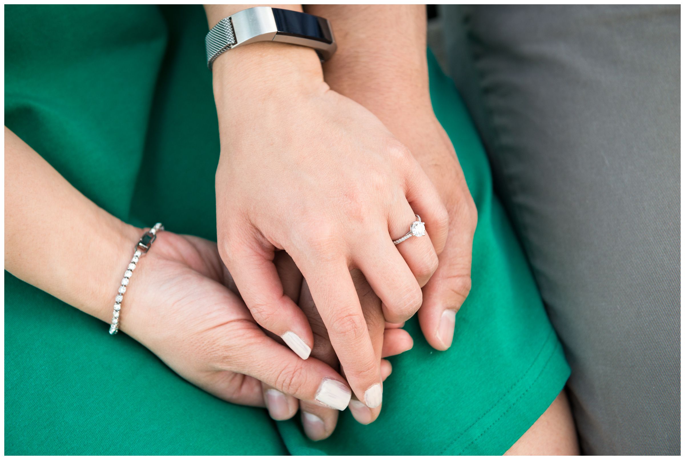 engaged couple holding hands