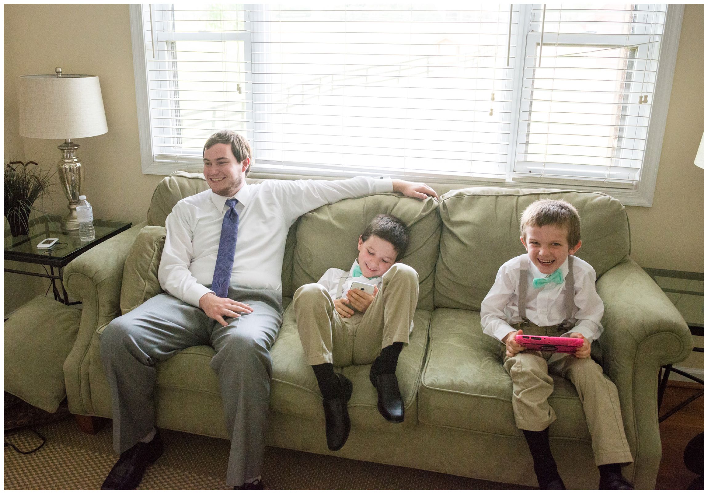 groom hangs out with ring bearers before wedding ceremony