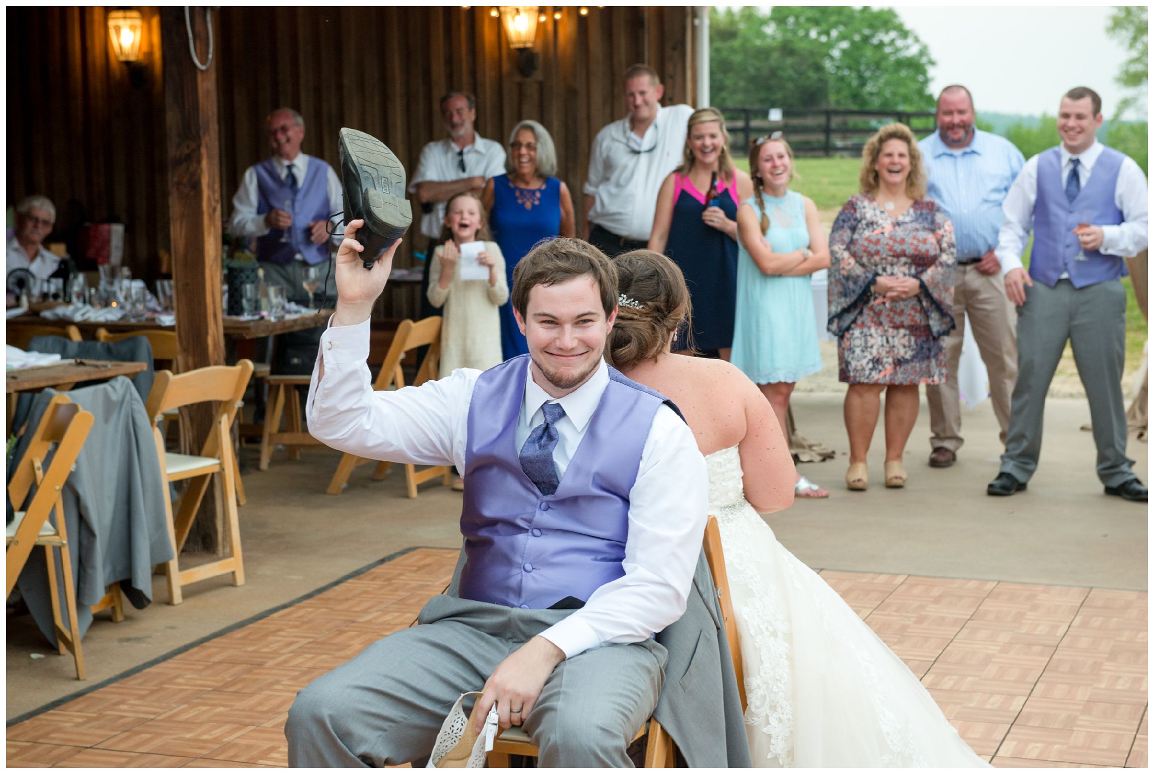 bride and groom play shoe game at barn wedding reception at Wolftrap Farm in Virginia