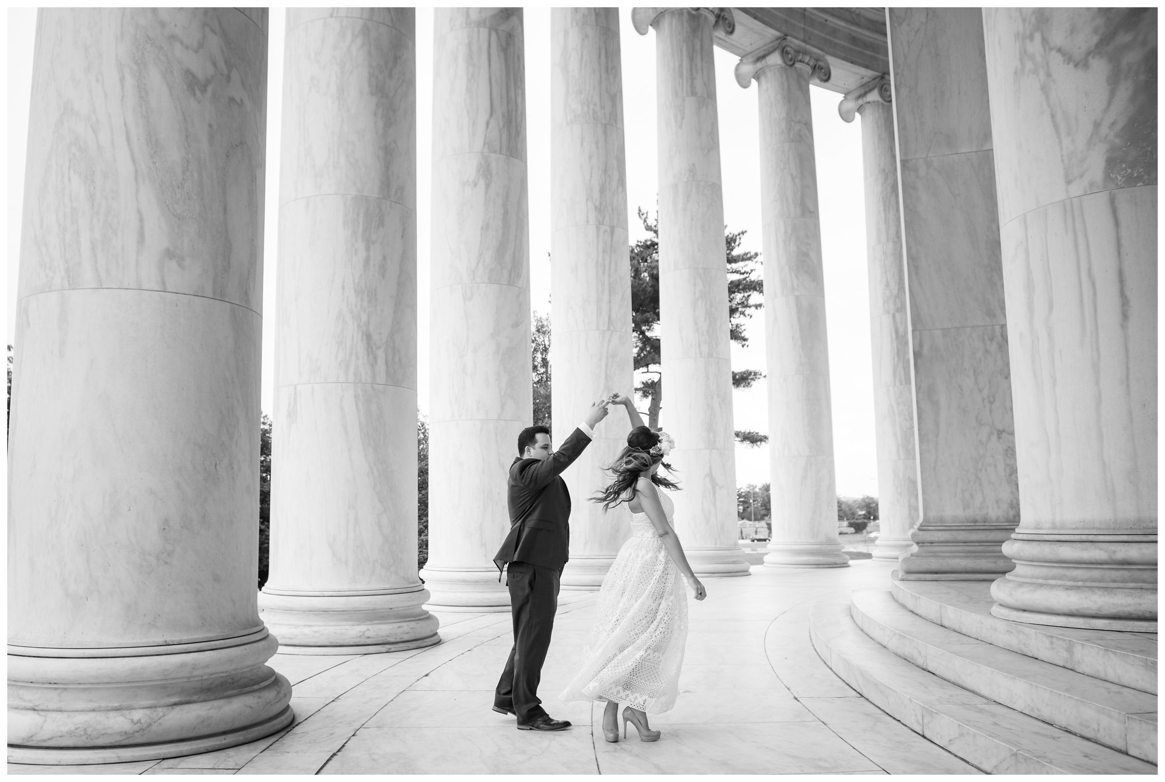 groom twirling bride amongst columns at the Jefferson Memorial during DC monument wedding day in Washington