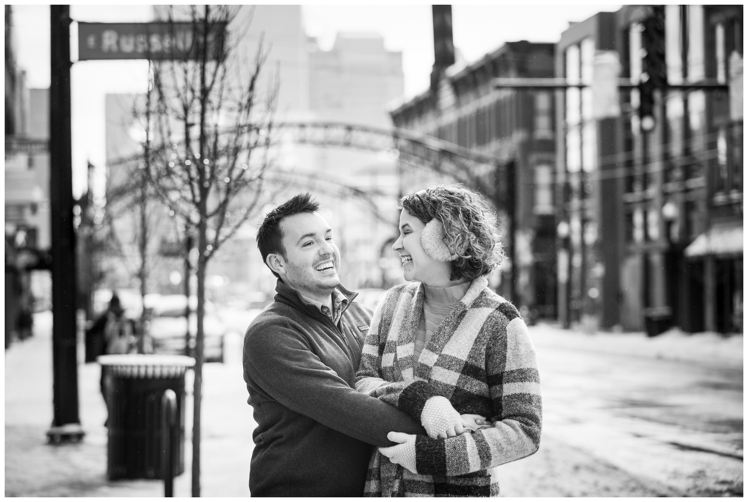 engaged couple on High Street in the Short North neighborhood of Columbus, Ohio during snowy winter engagement session