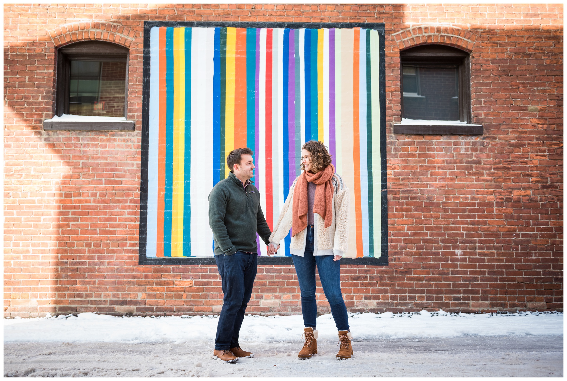 winter engagement photos in front of brick wall and mural in the Short North area of Columbus, Ohio