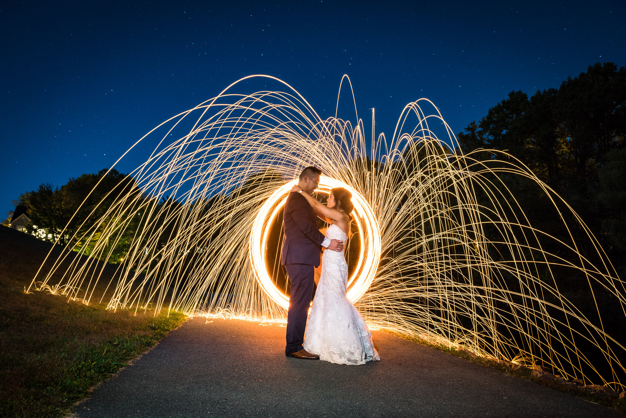 bride and groom with ring of fire raining fire nighttime long exposure wedding photography