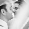 black and white wedding photo of bride and groom under veil