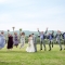 bridal party jumping into the air during rustic farm wedding