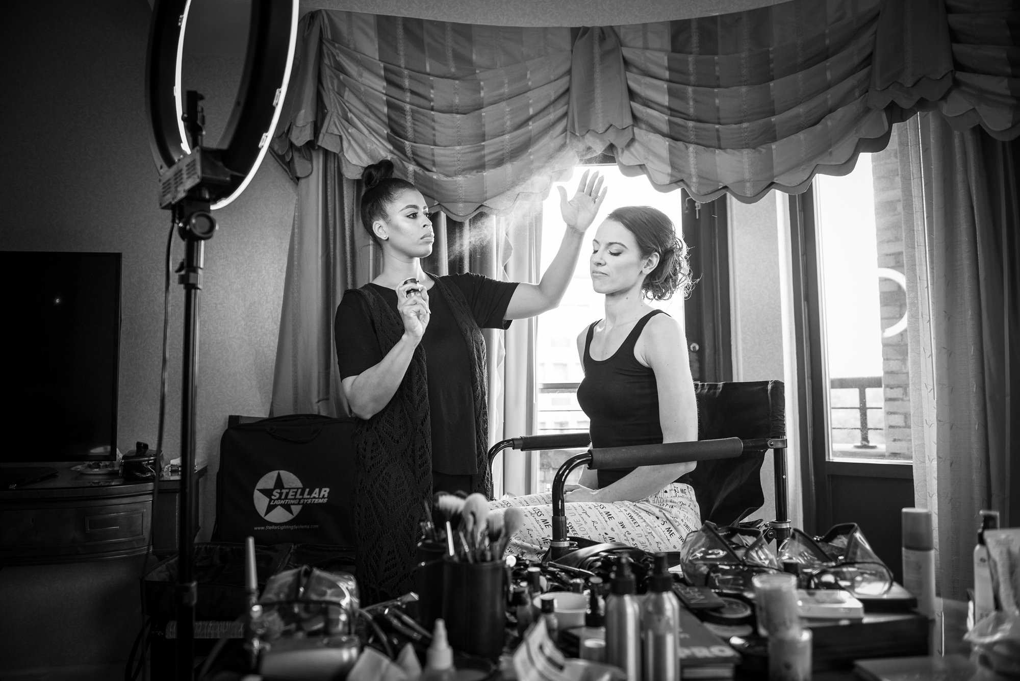 bride getting her hair done on wedding day