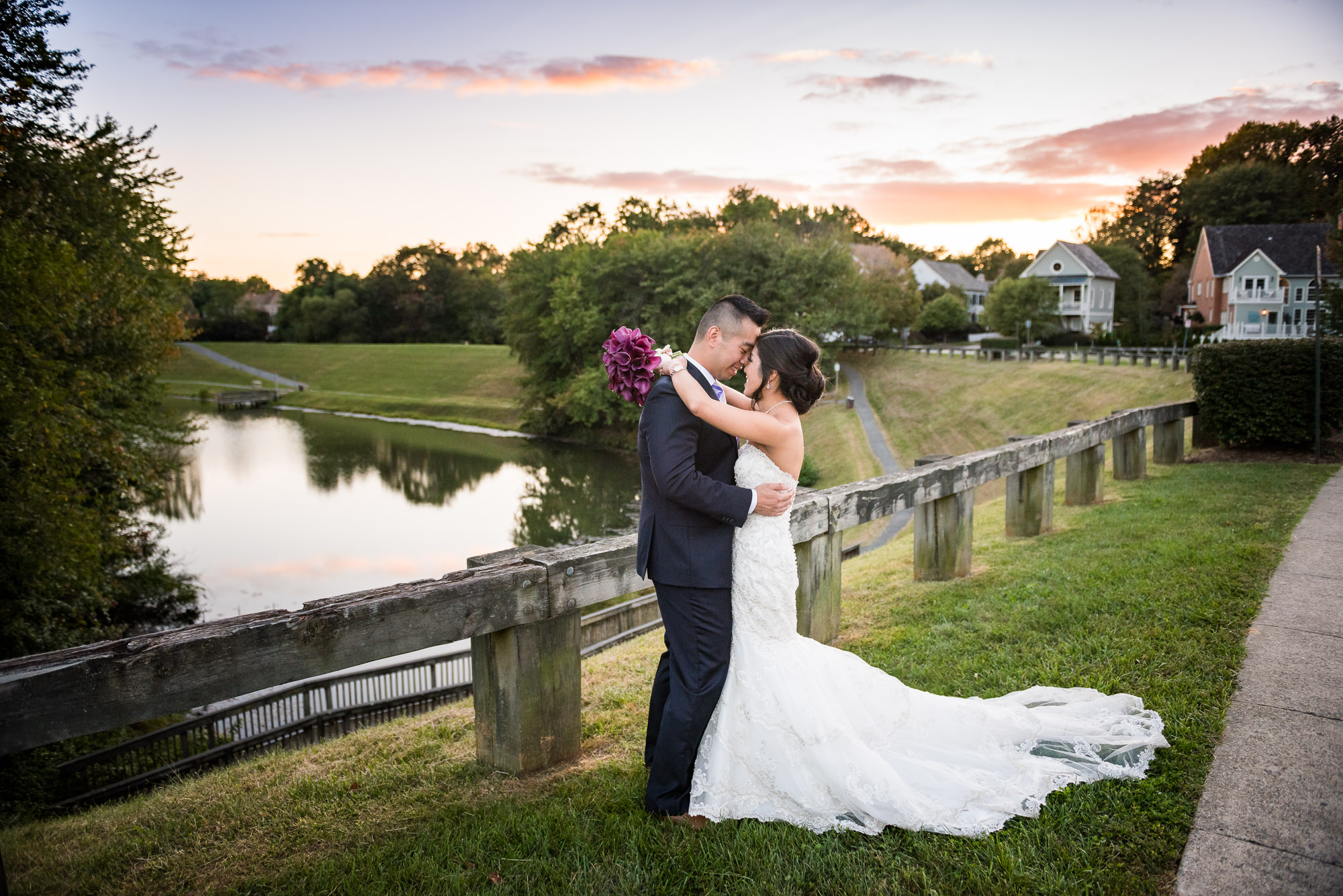 Asian wedding couple at sunset near lake