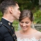 Marine groom kissing bride after military wedding