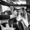 wedding party cheers in limo on the way to reception