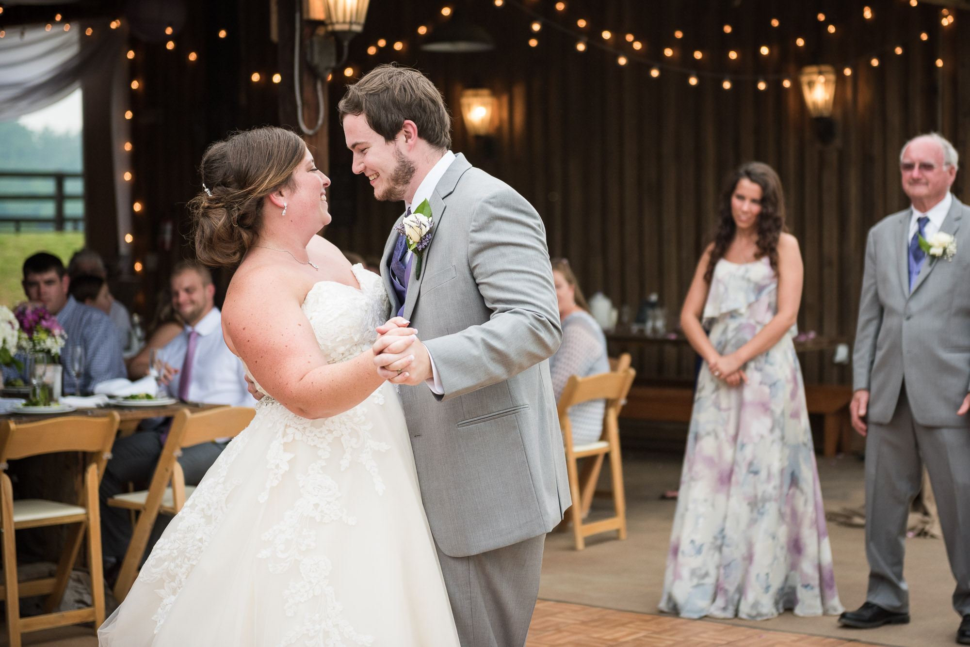 bride and groom first dance candid by rustic barn wedding photographer