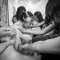 bridesmaids praying with bride before wedding by Columbus wedding photojournalist