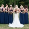 bride with bridesmaids in long navy gowns