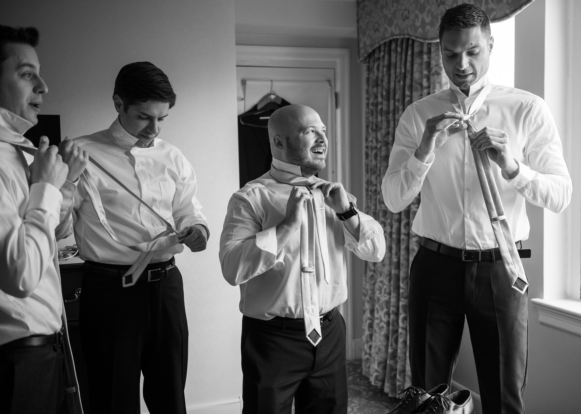 wedding photojournalism candid photos of groomsmen getting ready on wedding day