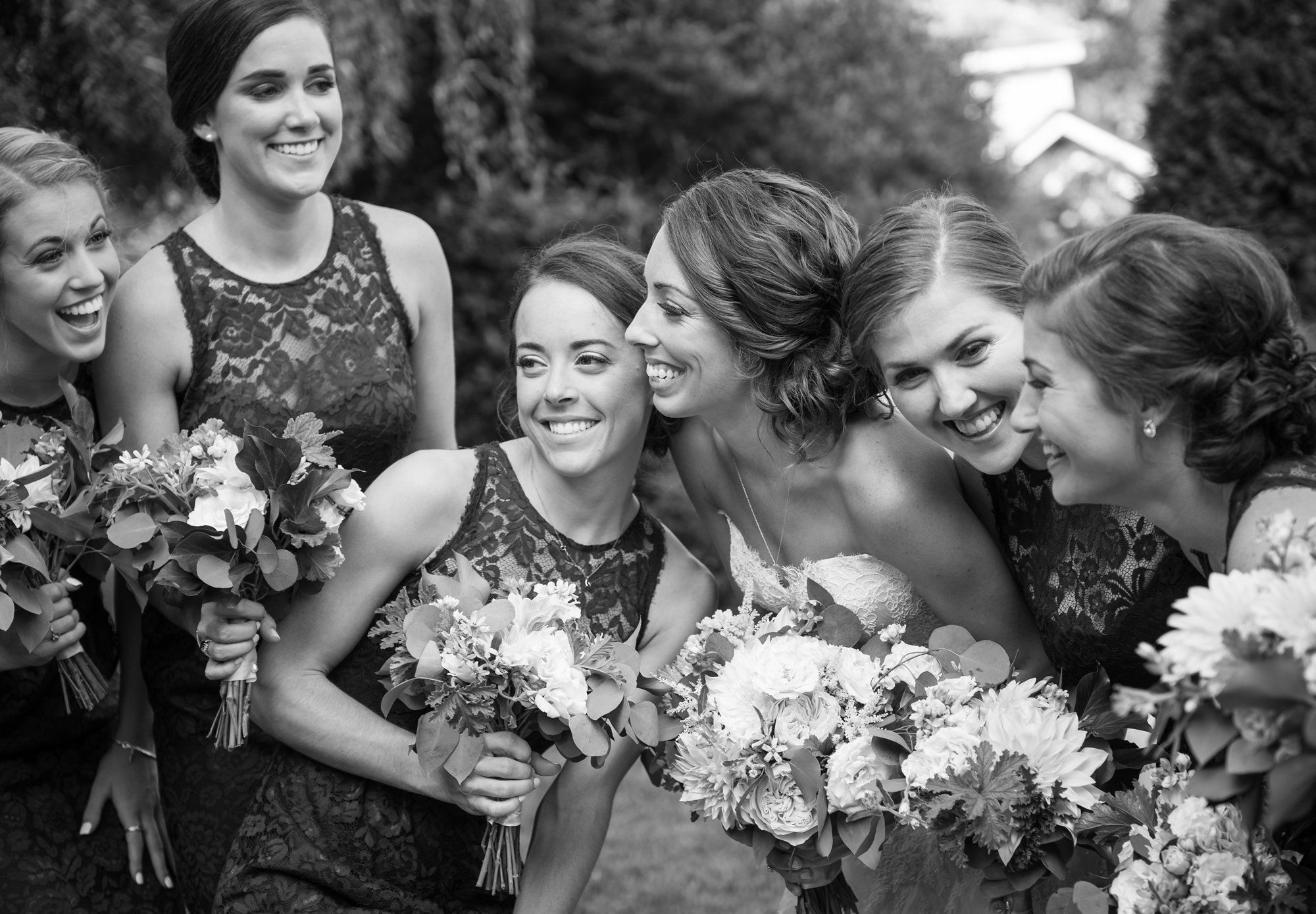 bride laughing with bridesmaids candid wedding photography