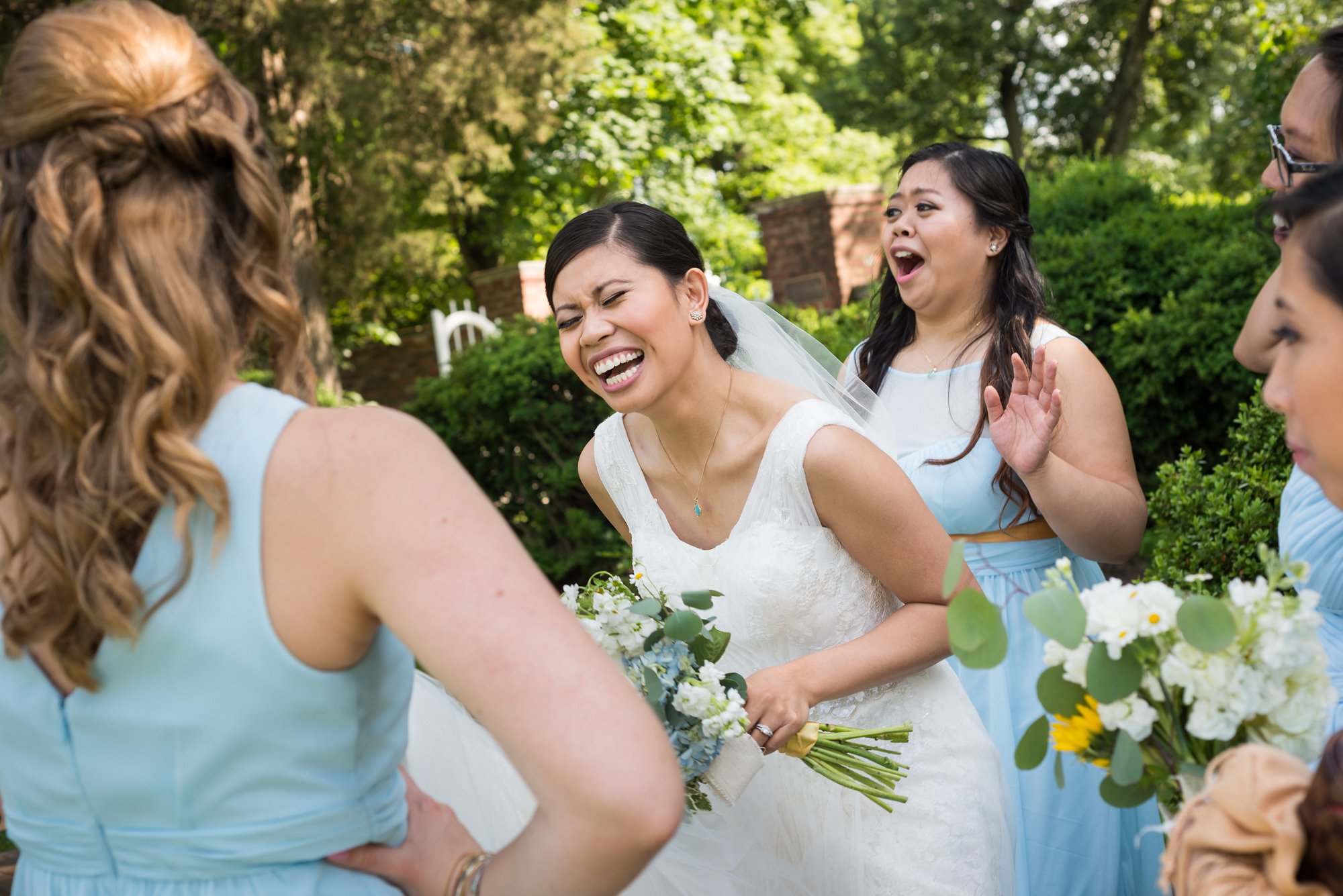 candid photo of bride and bridesmaids laughing by Columbus wedding photojournalist