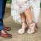 bride wearing pink glittery pumps with pom poms