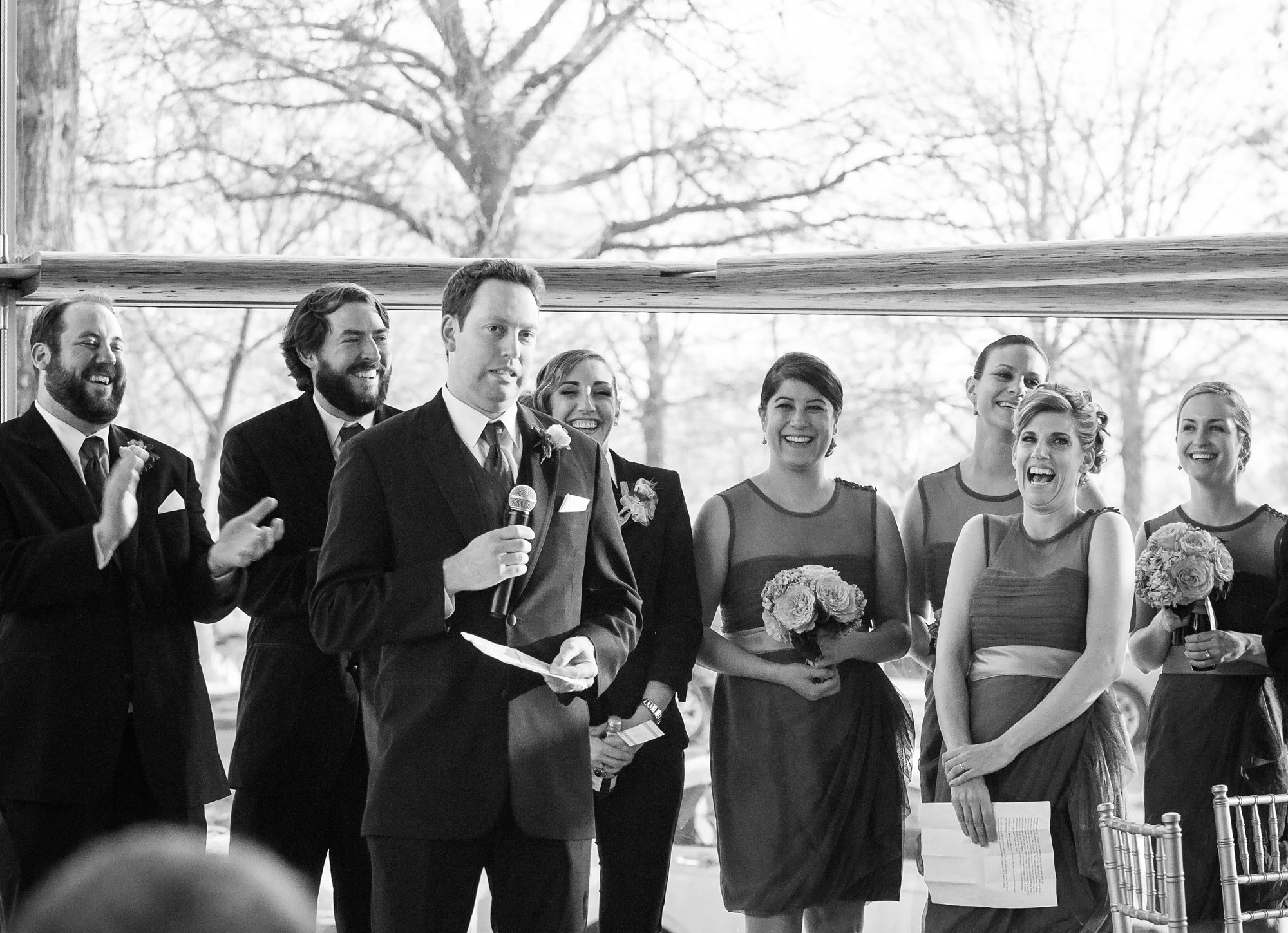 wedding party laughing turing wedding reception toasts