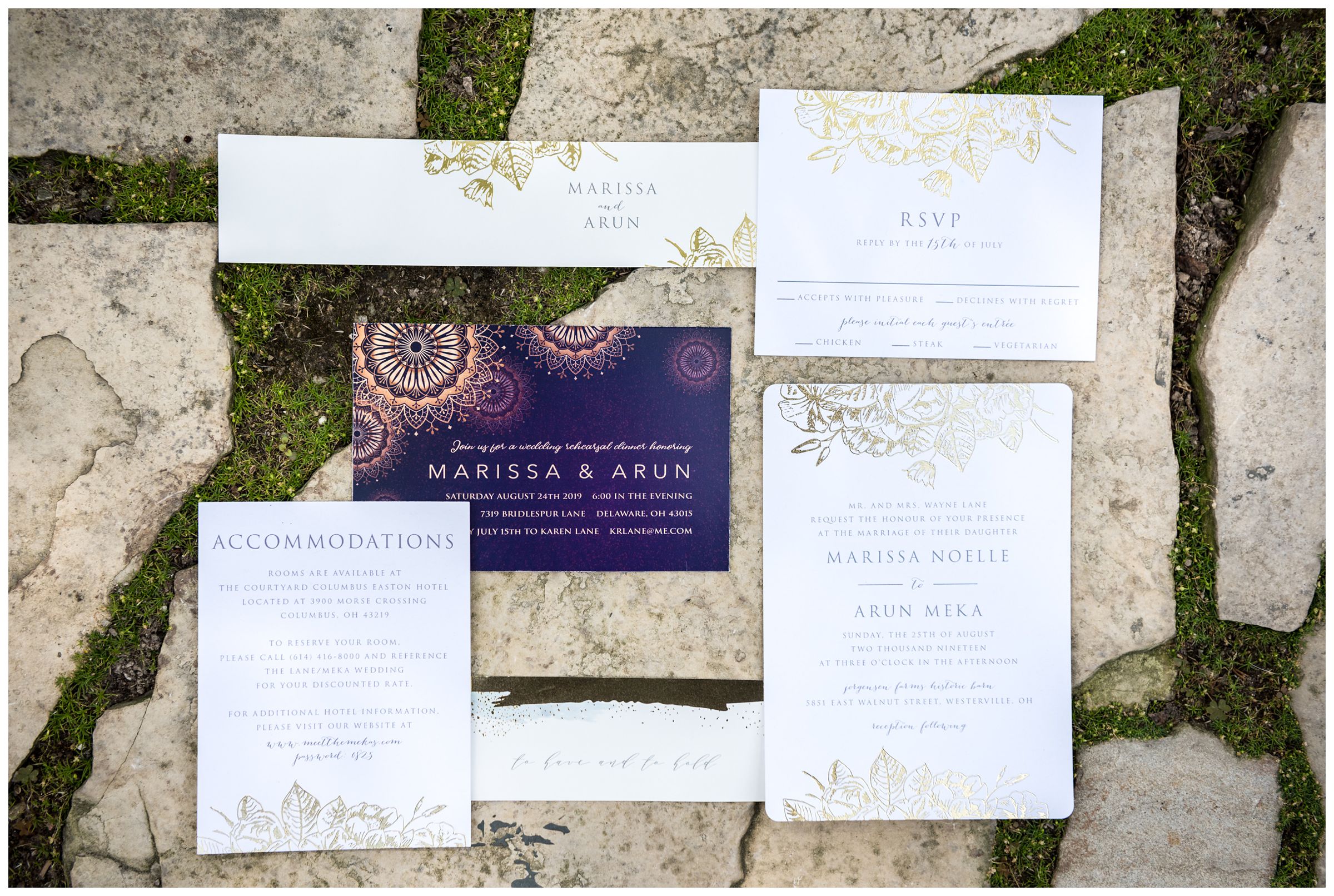 purple and gold wedding invitation suite on mossy stone walkway at Columbus Ohio wedding
