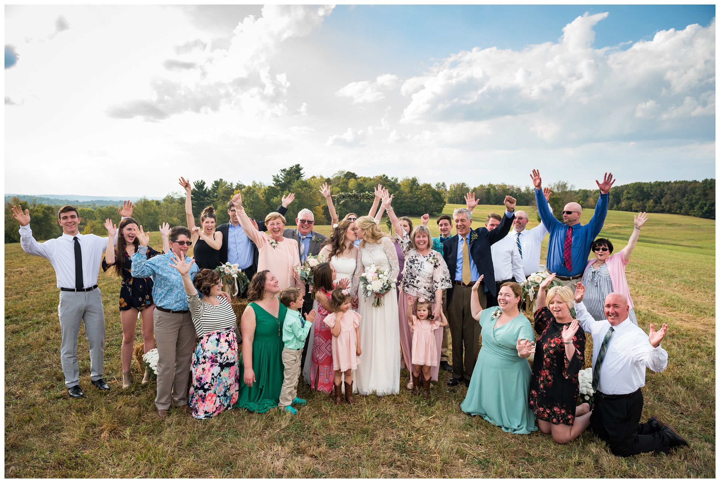 family celebrates with two brides on wedding day